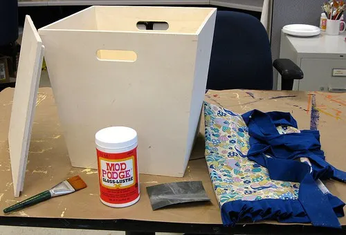 Wood bin, bottle of Mod Podge, apron and a paintbrush
