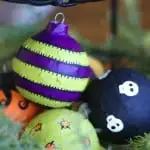 In this budget friendly, recycled Halloween craft, you'll use Mod Podge and old Christmas ornaments to make these cool Halloween ornaments!