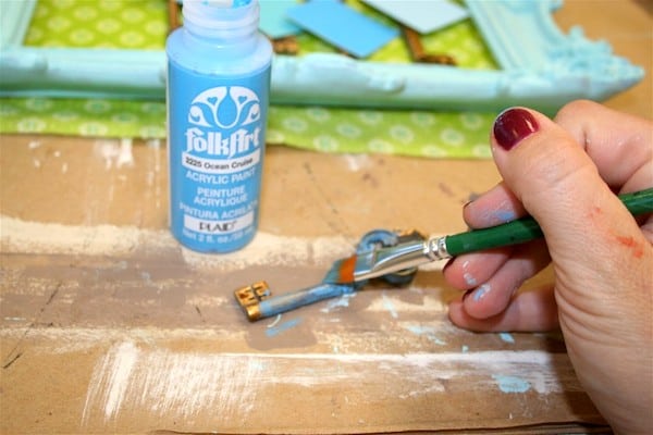 Painting a faux key with blue paint