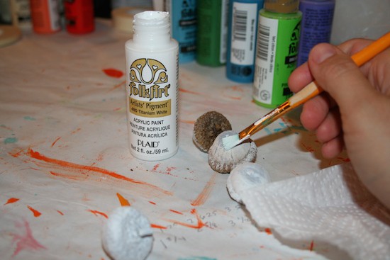 Painting acorns with white craft paint