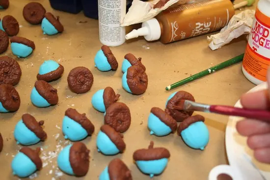 Painting the tops of acorns with brown paint