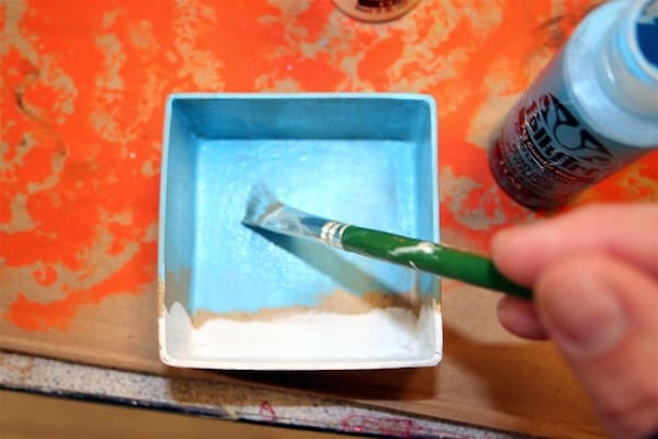 Painting a paper mache box with blue and white paint