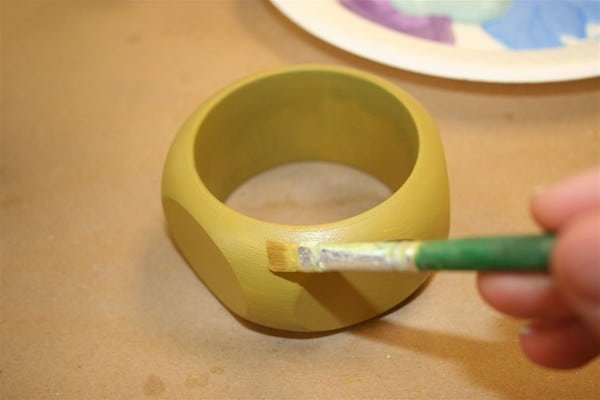 Paint a coat of acrylic paint on a wood bracelet