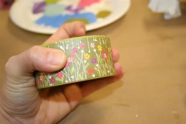 Wrap paper around a wood bracelet and glue with Mod Podge
