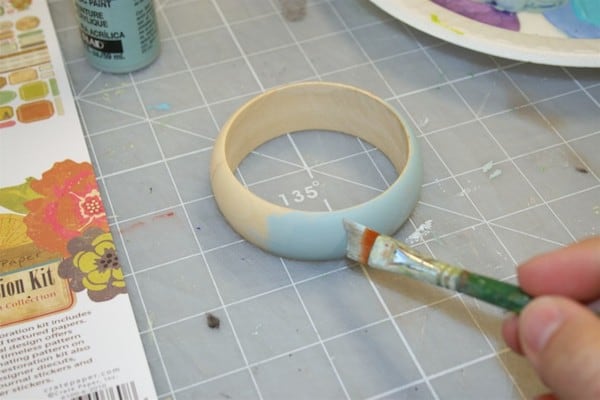 Paint a bangle bracelet with blue acrylic paint