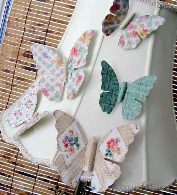 Turn antique metal butterflies into pretty magnets with wallpaper and Mod Podge. Use these easy butterfly decorations in your home decor!