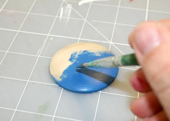 Painting a wood pendant with blue paint