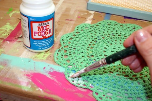 Add Fabric Mod Podge to a round green doily from Michaels