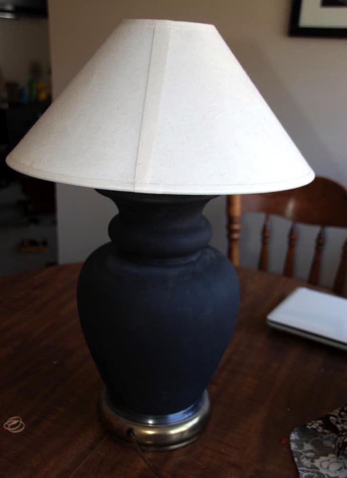 Lamp with a black base and light shade