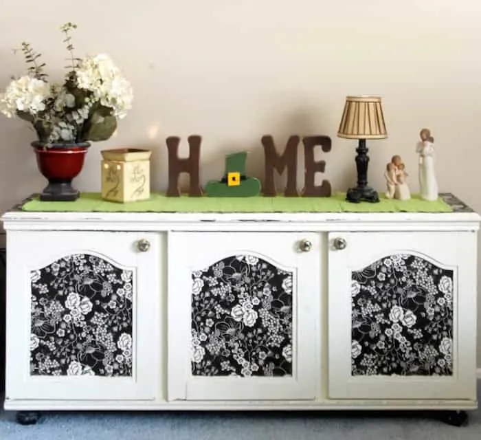 Decoupage TV cabinet with fabric on the front of the doors