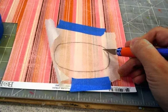 Cutting paper out to fit the buckle using the template