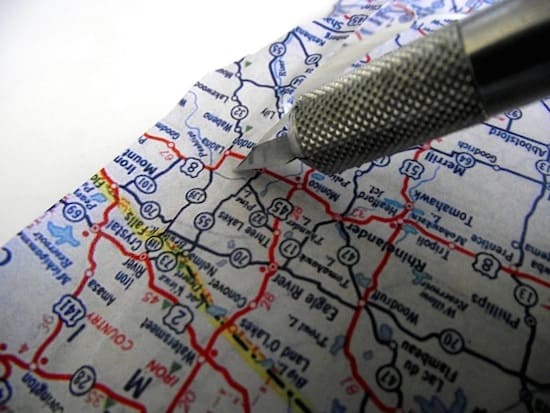 Cutting the edge of a map with a craft knife