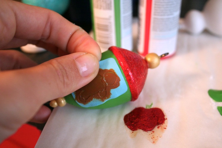 Applying paint to a Christmas ornament