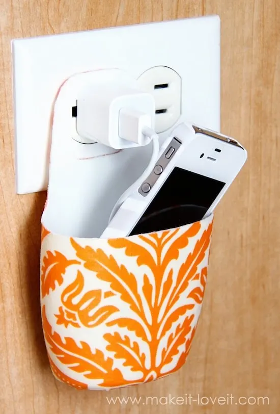 Not sure where to put your phone while it's charging? Make a cell phone holder from a lotion bottle using Mod Podge, and keep it near the plug.
