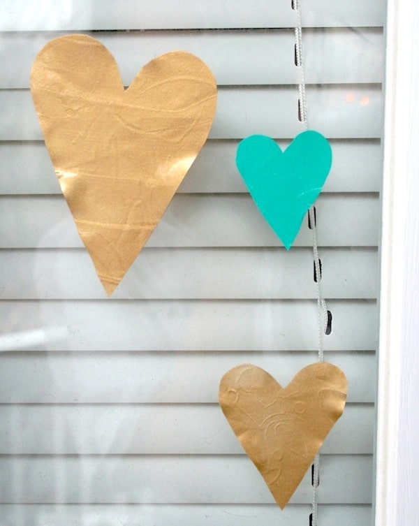 This valentine's craft for kids is so easy - all you need is colorful acrylic paint and Mod Podge to make these fun heart glass clings.