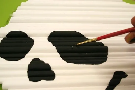 Painting the eyes with black acrylic paint