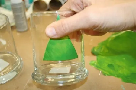 Applying a Christmas tree window cling to a glass container