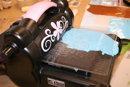 Cutting the window cling material with a Sizzix