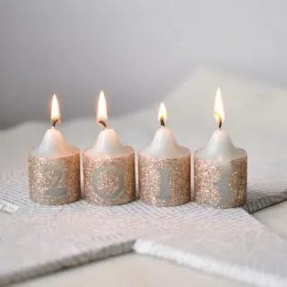 You can easily decorate candles with this quick tutorial - all you need are glitter, Mod Podge and vinyl stickers. It's very budget friendly!