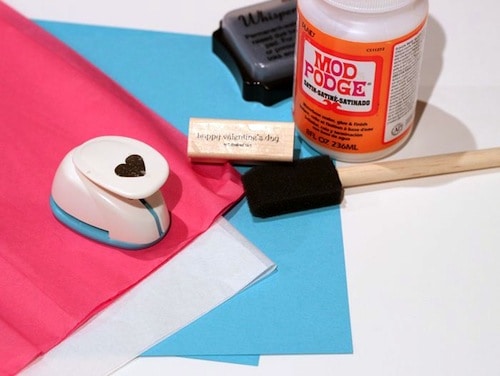 Tissue paper, cardstock, heart punch, stamp, Mod Podge, stamp pad, and foam brush