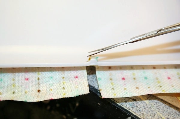Cutting ports out of the fabric with detail scissors