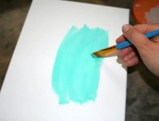 Painting on canvas with turquoise paint