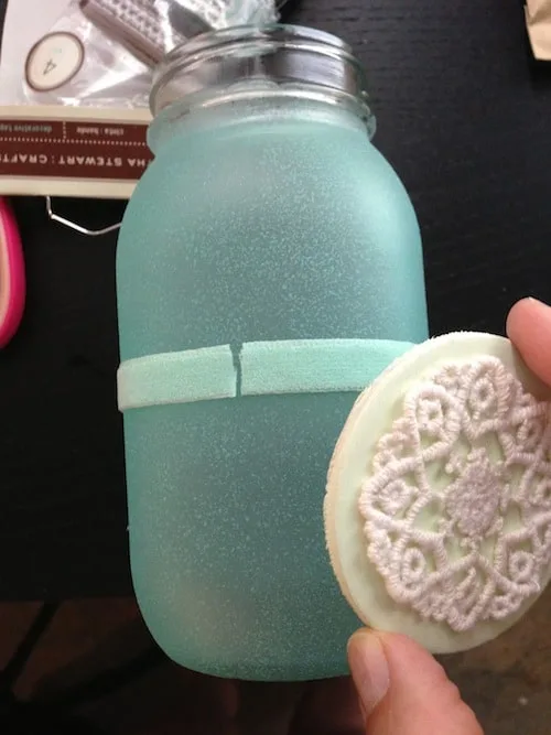 Gluing a wood circle to a jar frosted with glass paint