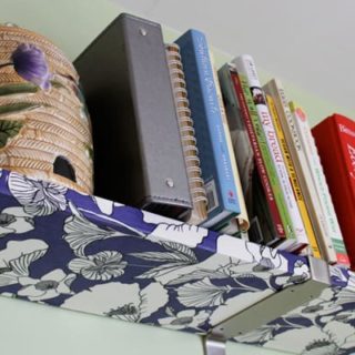 Give those boring shelves a complete makeover - decoupage fabric with Mod Podge Hard Coat - this is an easy and budget friendly project!