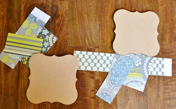 Cut scrapbook paper and MDF frame bases