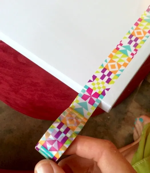 Applying washi tape to a dry erase board