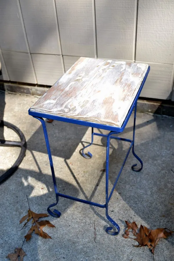 Spray painted iron table frame with wood
