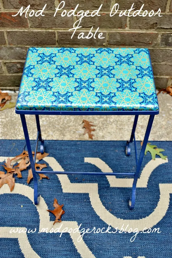 Overhaul a small metal patio table using Mod Podge Outdoor! It's easy to do with one of your favorite patterns of wrapping paper.