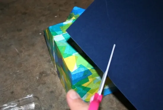 Cutting pieces out of navy blue cardstock