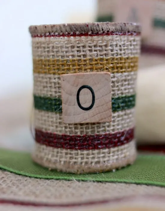 Use recycled paper towel rolls to make these burlap DIY napkin rings. You'd never guess they were made for pennies! Perfect for the holidays.