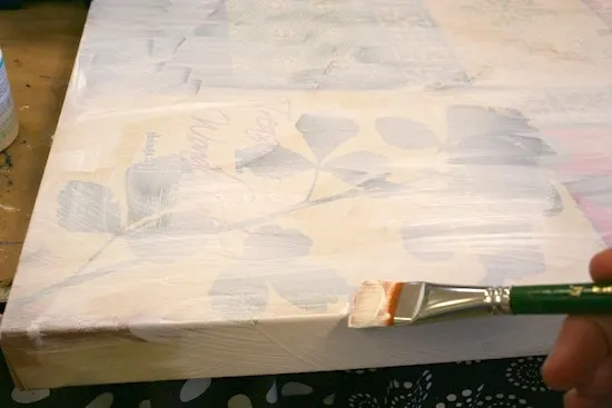 Painting a canvas with white gesso to cover
