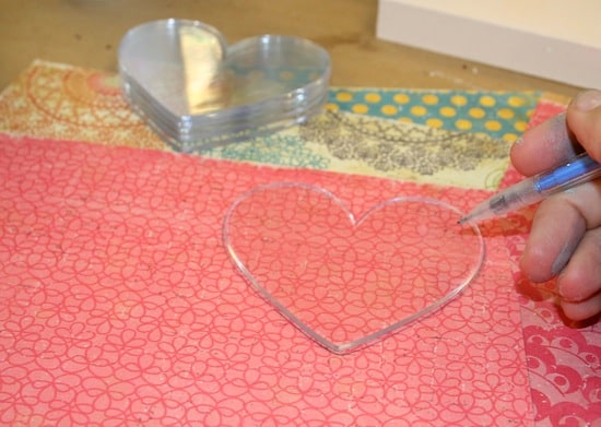 Tracing clear acrylic shapes onto scrapbook paper