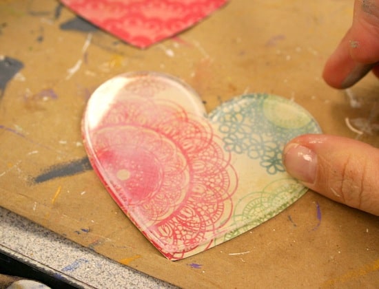 Mod Podging a clear acrylic heart to scrapbook paper