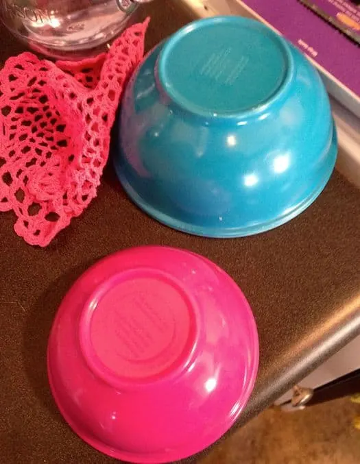 Blue and pink bowls sitting on a counter