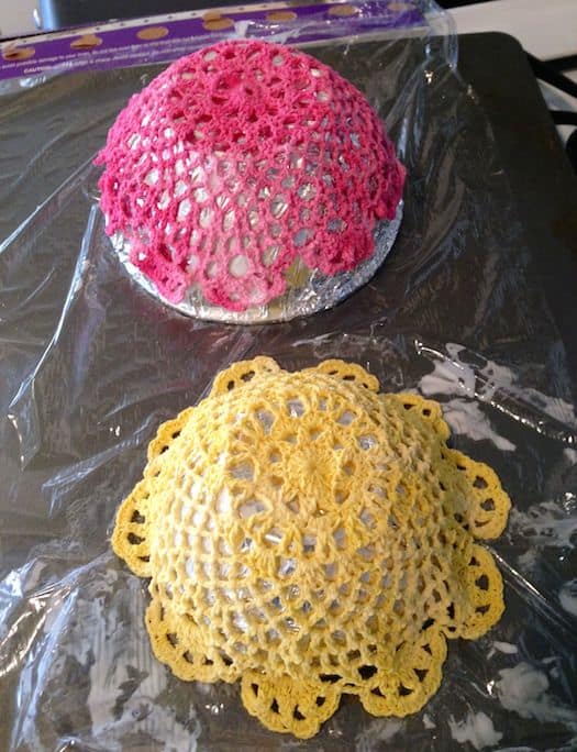 Doilies with fabric stiffener drying on a cookie sheet