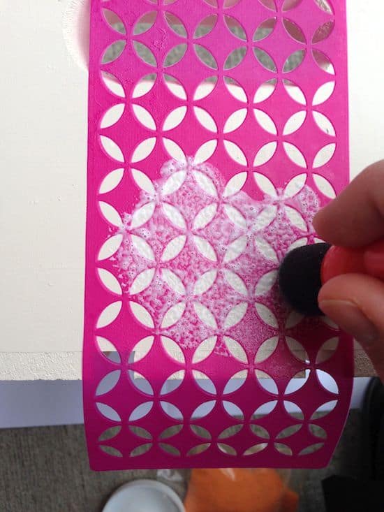 Adding Mod Podge to an adhesive stencil with a foam spouncer