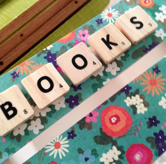 Adding scrabble tiles spelling "BOOKS" to the side of the wood crate