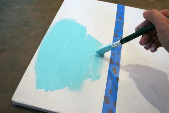 Painting on the end of a canvas with aqua blue