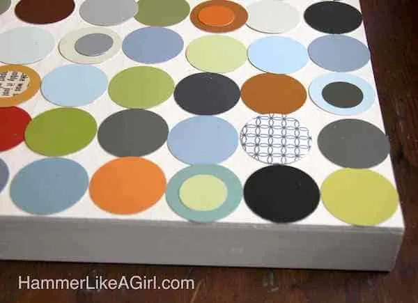 Paint chips layered on top of a wood canvas