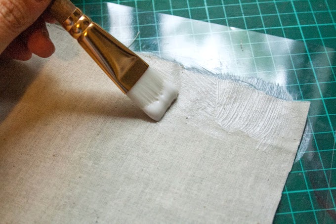 Paint fabric with Mod Podge and a paintbrush