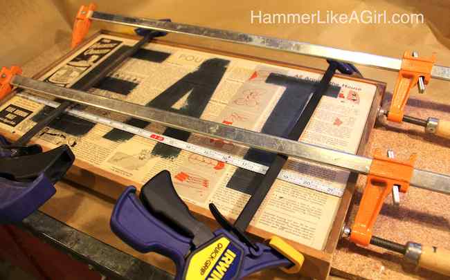 Clamping the wood sign frame in place with large clamps