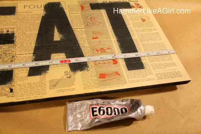 Attaching a measuring tape to a decoupage wood sign with E-6000