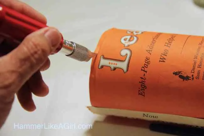 Trim the excess paper at the top and bottom with a craft knife