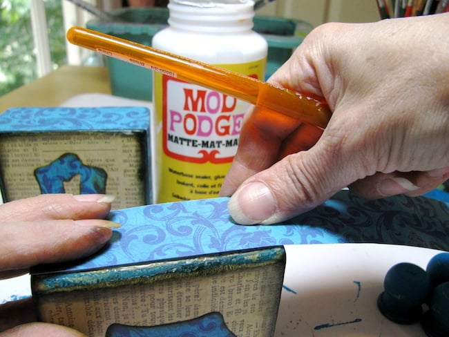 Adding paper to the sides of the blocks with Mod Podge
