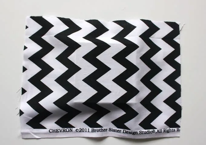Black and white zig zag fabric smoothed down on the top of a gift box