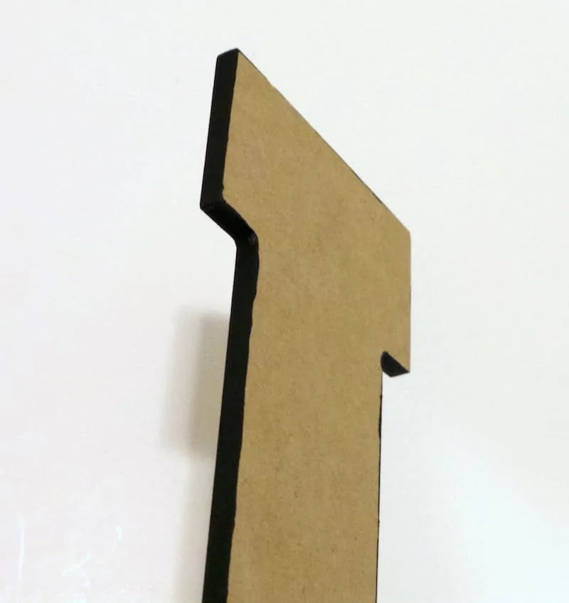 Wood letter painted with black craft paint on the edges